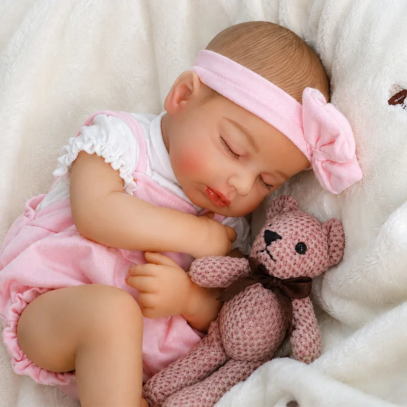Pink Bow sleeping reborn baby doll with soft vinyl finish with hand-painted realistic detailing.