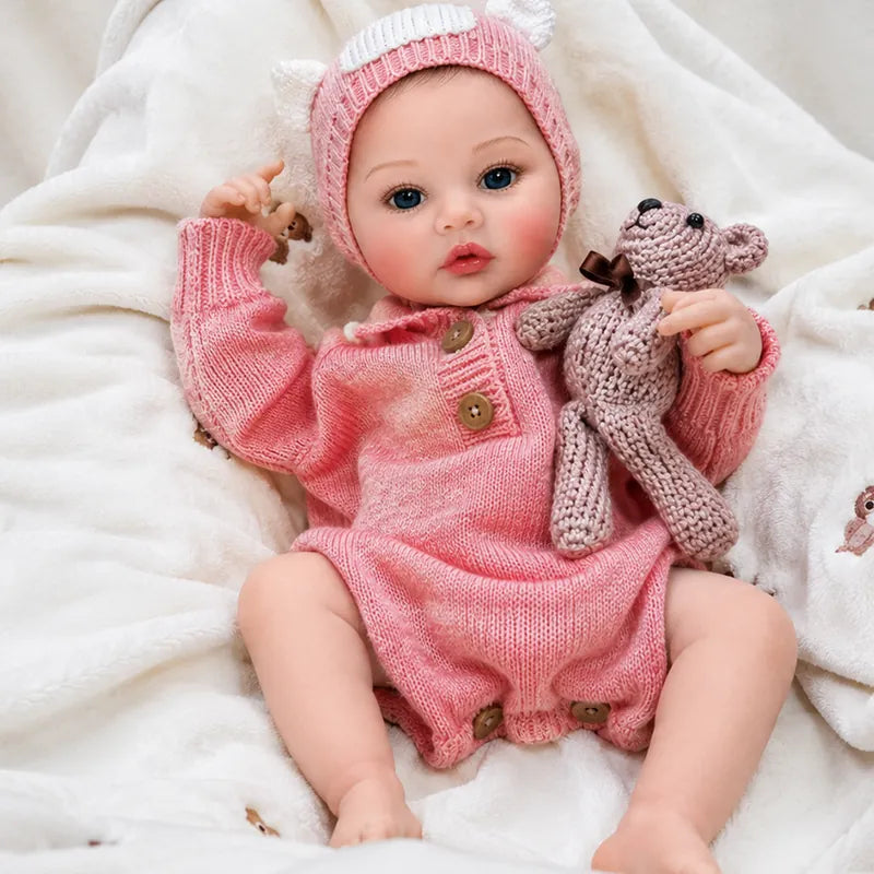 reborn baby doll resting on soft white blankets, ideal for nursery displays, imaginative play, photography, or gifting.