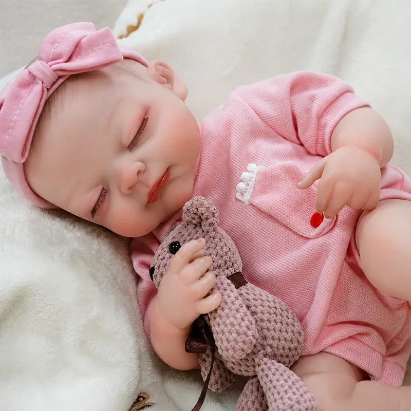 Realistic sleeping reborn doll featuring delicate eyelashes, softly blushed cheeks, tiny fingers, and detailed baby feet.