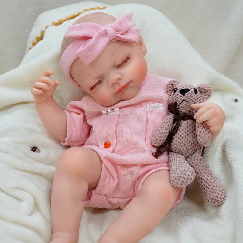 Handcrafted reborn baby doll with carefully painted skin tones, realistic facial shading, and finely sculpted newborn features.