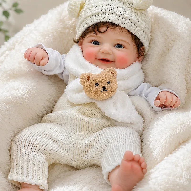 Full Silicone Reborn Baby Doll resting comfortably on a soft white blanket in a cozy nursery setting.