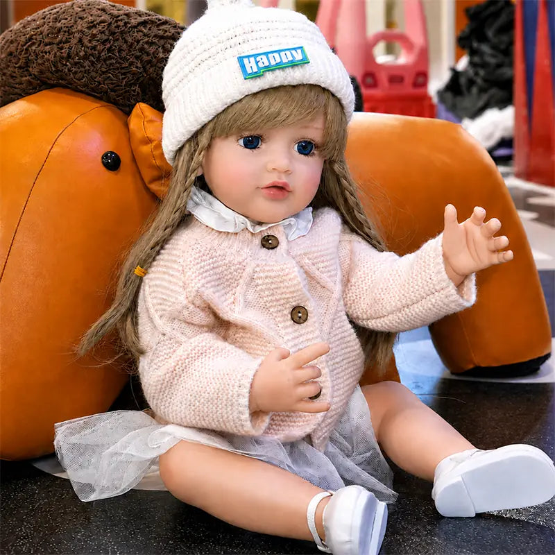 Close-up of a realistic reborn doll with expressive blue eyes, softly painted lips, delicate eyelashes, blushed cheeks, and sculpted fingers.