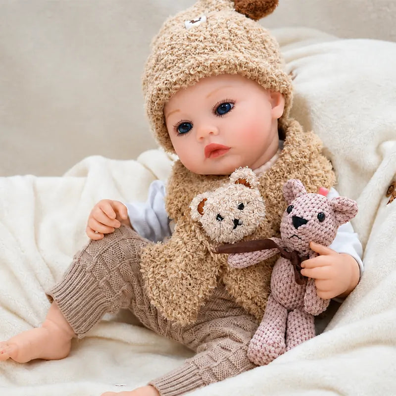 Reborn baby doll featuring hand-painted lips, softly blushed cheeks, delicate eyelashes, and vivid blue eyes.