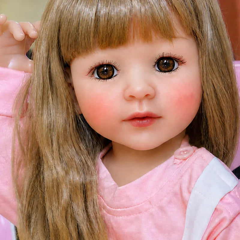 Hand-finished realistic reborn doll with smooth soft-touch skin, carefully painted facial details, and finely styled blonde hair.