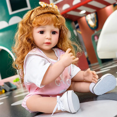 Lifelike reborn girl doll enjoying a cheerful day at a colorful American-style funfair, dressed in a sweet pink casual outfit.