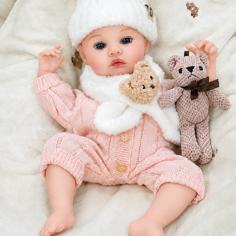 Close view of Rosie reborn doll featuring delicate eyelashes, softly blushed cheeks, natural pink lips, and detailed fingers and toes.