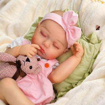 Pink Bow sleeping reborn baby doll closed eyes with painted eyebrows, rooted hair, glossy lips, curled fingers