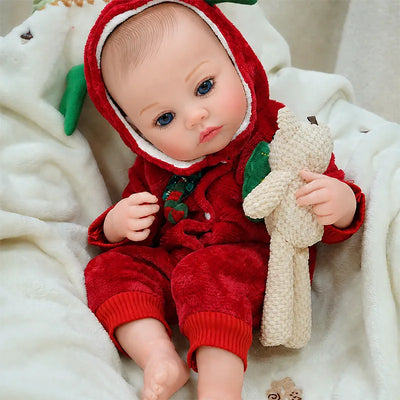 Adorable reborn baby doll cuddling a bunny on a soft blanket while dressed as Santa’s little reindeer helper.