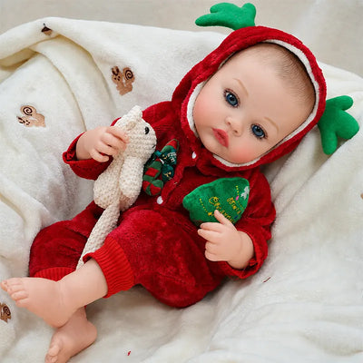 Festive reborn baby doll resting on a cozy blanket, perfect for Christmas displays, holiday photos, and pretend play.