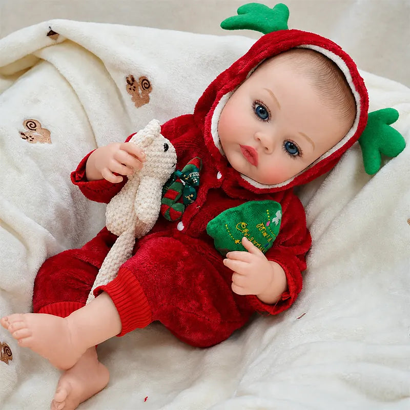 Festive reborn baby doll resting on a cozy blanket, perfect for Christmas displays, holiday photos, and pretend play.