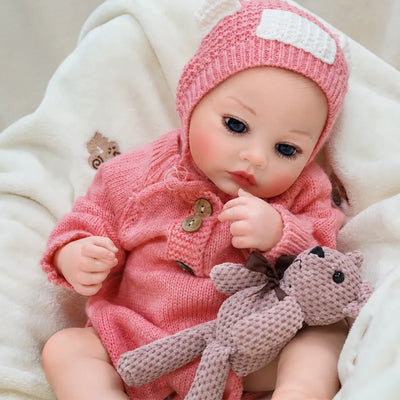 Handcrafted reborn doll with layered skin painting, realistic facial shading, rooted-style hair, and carefully finished features.