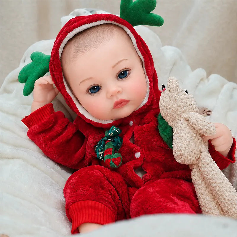 Christmas Reborn Baby Doll in a red reindeer outfit holding a plush bunny and festive heart.
