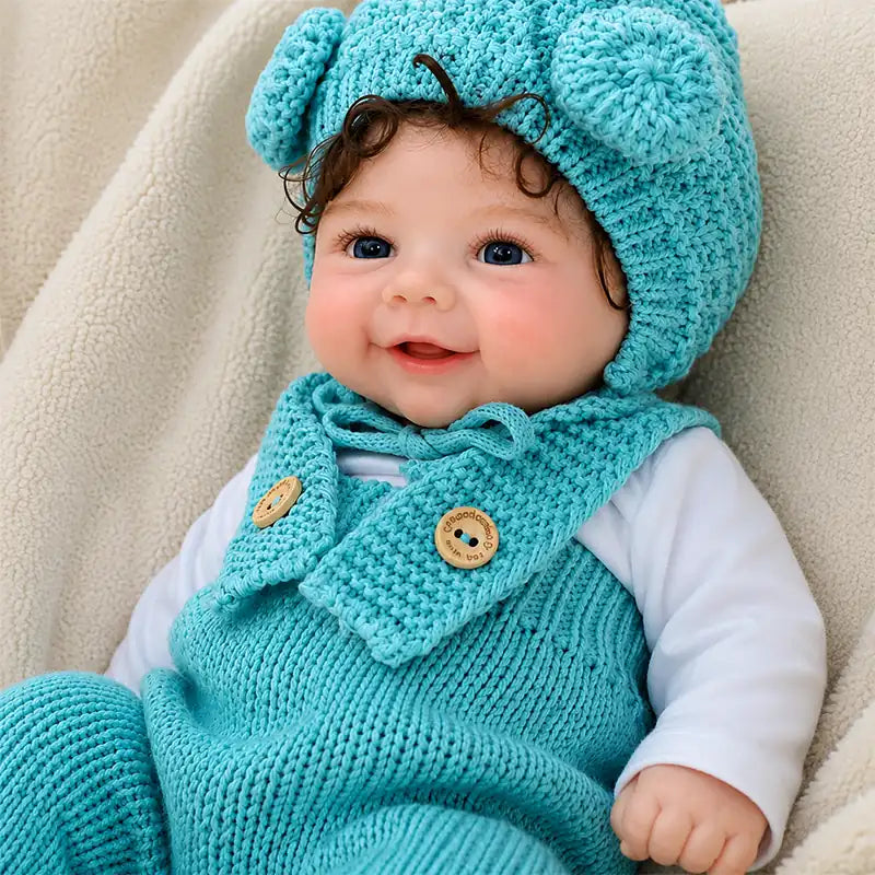 Full Silicone Reborn Baby Doll Wearing a Turquoise Knitted Outfit and Cute Pom-Pom Hat