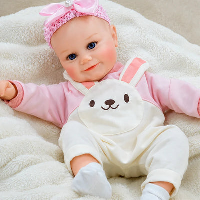 Handcrafted reborn baby doll featuring detailed skin painting, natural blush, and realistic facial sculpting.