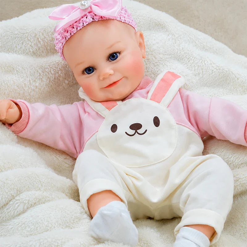 Handcrafted reborn baby doll featuring detailed skin painting, natural blush, and realistic facial sculpting.