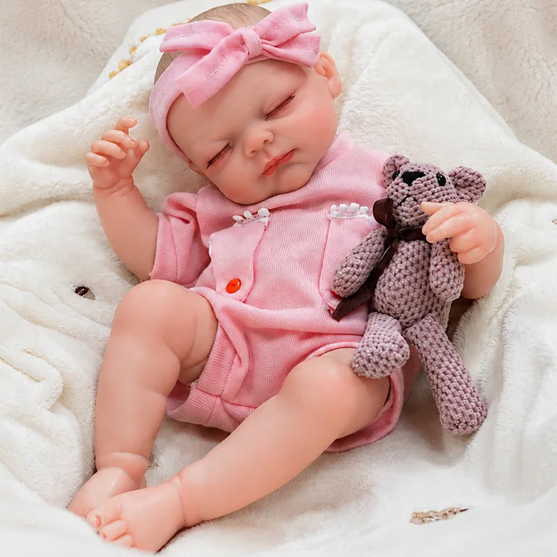 Lifelike reborn baby doll resting on a soft nursery blanket, perfect for pretend parenting, cuddling, and bedtime play.