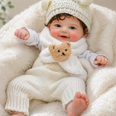 Full Silicone Reborn Baby Doll resting comfortably on a soft white blanket in a cozy nursery setting.