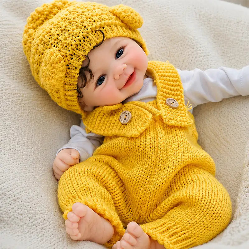 Smiling Full Silicone Reborn Baby Doll Wearing a Bright Yellow Hand-Knitted Outfit and Hat