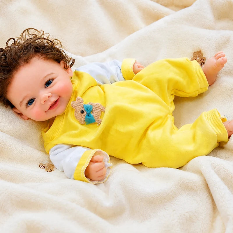 Full-Body Silicone Reborn Baby Doll featuring bright blue eyes, curly brown hair, tiny fingers, and detailed toes. 