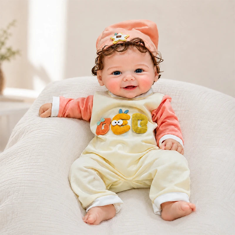 Full Silicone Reborn Baby Doll with bright blue eyes, an open-mouth smile, a peach hat, and a playful animal romper. 