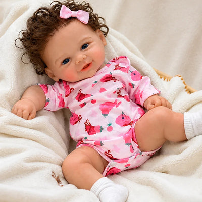 Smiling Full Silicone Reborn Baby Doll Wearing a Pink Floral Romper and White Socks