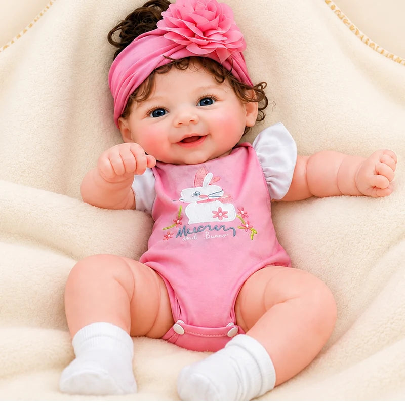 Full Silicone Reborn Baby Doll with lifelike skin, bright blue eyes, and an adorable smiling expression. 