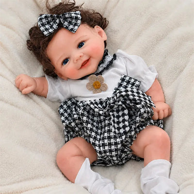 Full Silicone Reborn Baby Doll with a lifelike smiling face, curly brown hair, bright blue eyes, and realistic baby details.