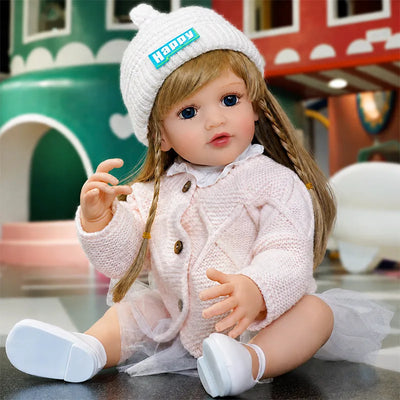 Sweet fashion-themed reborn doll in a “Happy” beanie and blush-pink outfit, bringing a playful and cheerful personality to every scene.