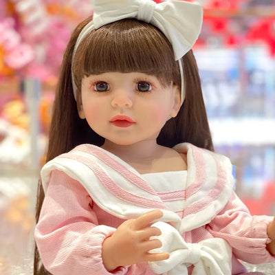 Soft-touch vinyl reborn toddler doll with detailed hand-painted features, realistic skin tones, and carefully crafted hands.