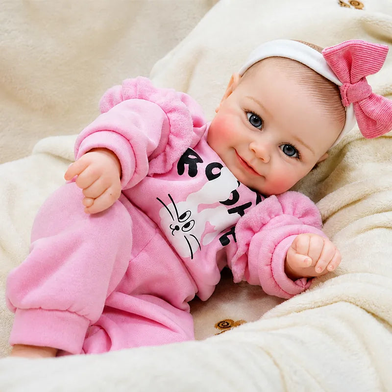 reborn baby doll resting on a soft cream blanket, perfect for nursery displays, imaginative play, and memorable gift giving.