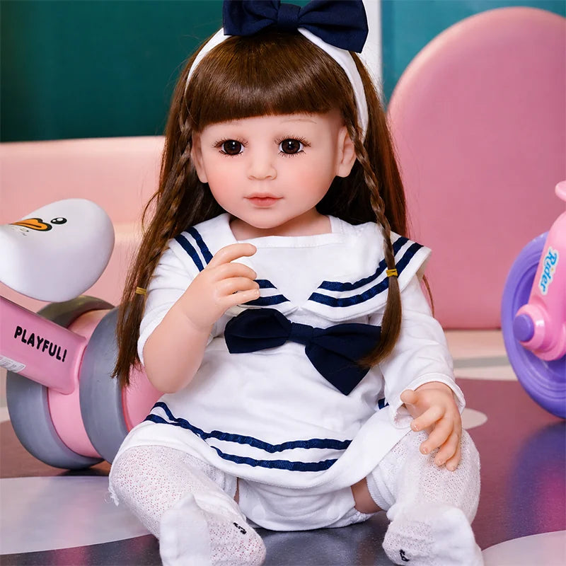 Close-up of Sophie reborn doll featuring detailed eyelashes, glossy brown eyes, rosy cheeks, and natural pink lips.