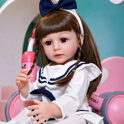 Sophie reborn girl doll with long brown braids, an expressive face, delicate fingers, and realistic baby-like features.