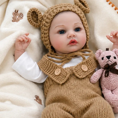 Realistic reborn baby doll with bright blue eyes, rosy cheeks, delicate eyelashes, and lifelike hand-painted facial details.