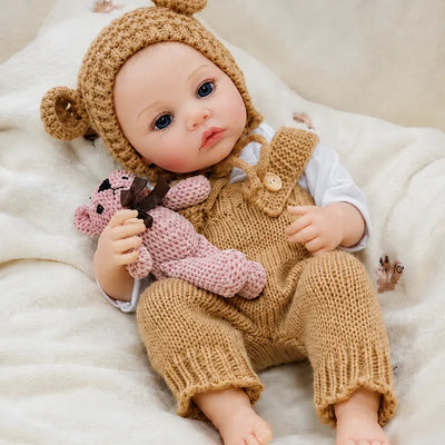 Close view of a reborn doll’s blue eyes, soft pink lips, tiny fingers, natural-looking toes, and gently blushed cheeks.