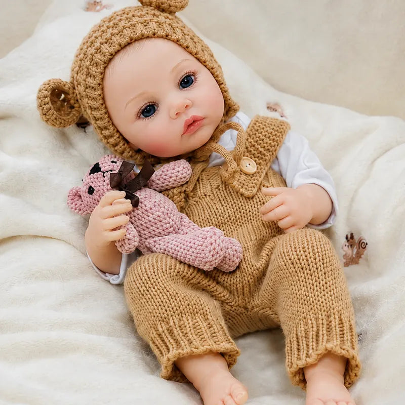 Close view of a reborn doll’s blue eyes, soft pink lips, tiny fingers, natural-looking toes, and gently blushed cheeks.