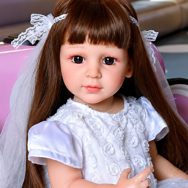 Lifelike reborn girl doll with long brown hair, blue eyes, and an elegant white princess dress.